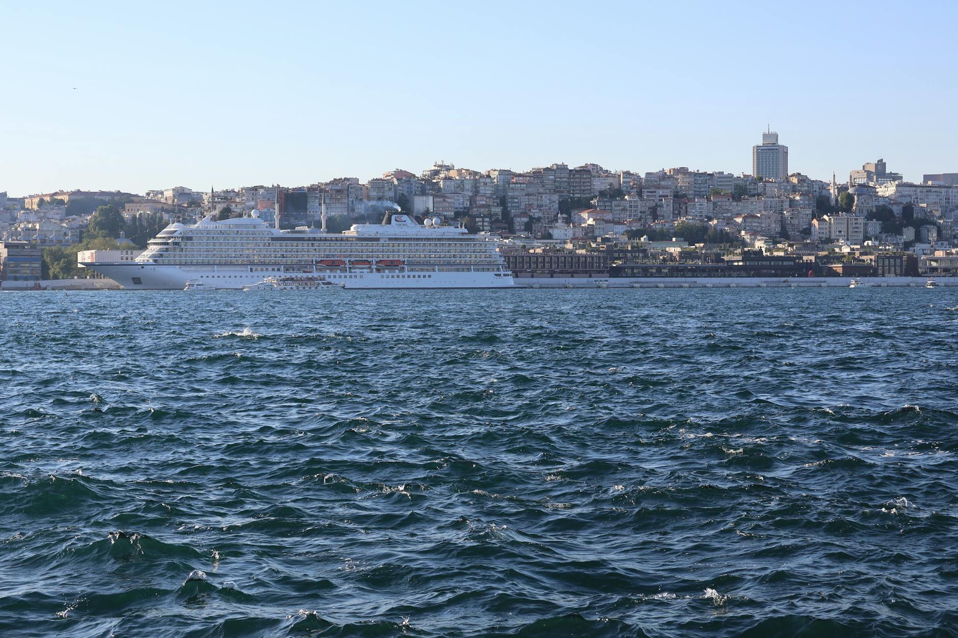 Large cruise ship docked at a port terminal